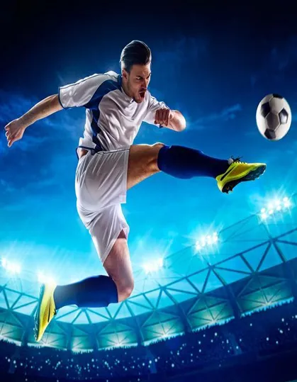 A man kicking a soccer ball on top of a field